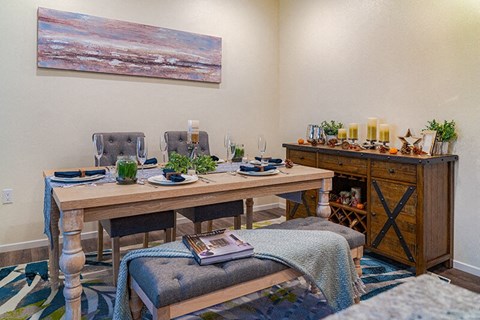 a living room with a dining table and a fireplace